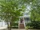 Inviting two-story home with a front porch, brick steps, and an American flag adding charm at 10859 Bedfordtown Dr, Raleigh, NC 27614
