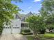 Charming two-story home with a well-manicured lawn, two-car garage, and inviting front porch at 10859 Bedfordtown Dr, Raleigh, NC 27614