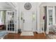 Foyer with hardwood floors, neutral walls, a white front door, and views to adjoining rooms at 10859 Bedfordtown Dr, Raleigh, NC 27614