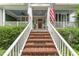 Inviting front entrance with brick stairs leading to a welcoming porch and front door at 10859 Bedfordtown Dr, Raleigh, NC 27614