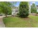 Charming two-story home with landscaped yard, inviting porch, and mature trees at 10859 Bedfordtown Dr, Raleigh, NC 27614