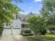 Charming two-story home with inviting porch, landscaped yard, and two-car garage at 10859 Bedfordtown Dr, Raleigh, NC 27614