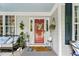 Charming front porch with seating area and decor accents at 10859 Bedfordtown Dr, Raleigh, NC 27614