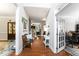 Inviting hallway featuring hardwood floors and neutral walls, leading to a home office at 10859 Bedfordtown Dr, Raleigh, NC 27614