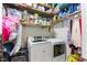 Functional laundry room with modern washer and dryer, shelving, and ample storage space at 10859 Bedfordtown Dr, Raleigh, NC 27614