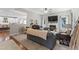 Open-concept living room with plush seating, fireplace and lots of natural light at 10859 Bedfordtown Dr, Raleigh, NC 27614