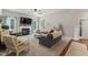 Comfortable living room with fireplace, plush seating, and a large window at 10859 Bedfordtown Dr, Raleigh, NC 27614