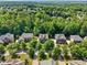 High aerial view of a residential neighborhood with lush green trees and well-maintained homes at 109 Aspenridge Dr, Holly Springs, NC 27540