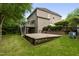 Large backyard featuring a patio, deck, and lush greenery at 109 Aspenridge Dr, Holly Springs, NC 27540