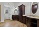 Elegant bathroom with dual vanities, dark wood cabinets, and a separate room at 109 Aspenridge Dr, Holly Springs, NC 27540