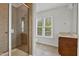 Bathroom with a walk-in shower, window and vanity with plenty of light at 109 Aspenridge Dr, Holly Springs, NC 27540
