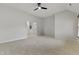Expansive bedroom with plush carpeting, neutral paint, and a connected room at 109 Aspenridge Dr, Holly Springs, NC 27540