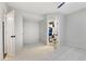 Bedroom with carpeted floors, ceiling fan and open bathroom entrance at 109 Aspenridge Dr, Holly Springs, NC 27540