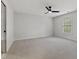 Spacious bedroom features plush carpeting, neutral paint, and a ceiling fan for added comfort at 109 Aspenridge Dr, Holly Springs, NC 27540