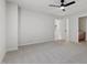 Spacious bedroom featuring plush carpeting, neutral paint, and a connected bathroom at 109 Aspenridge Dr, Holly Springs, NC 27540