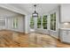 Open dining area features hardwood floors, bay window, and access to the deck with a lot of natural light at 109 Aspenridge Dr, Holly Springs, NC 27540