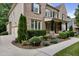 Charming brick and siding home with manicured landscaping, an attached garage, and a well-maintained lawn at 109 Aspenridge Dr, Holly Springs, NC 27540