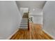 Bright foyer featuring hardwood floors, a carpeted staircase, and a view into a spacious room at 109 Aspenridge Dr, Holly Springs, NC 27540