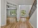 Bright and airy foyer with hardwood floors, staircase, and views into the living spaces at 109 Aspenridge Dr, Holly Springs, NC 27540