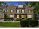 Charming two-story brick home with a beautifully landscaped front yard and a welcoming front porch at 109 Aspenridge Dr, Holly Springs, NC 27540