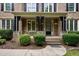 Close up of a welcoming front porch with stone accents and a stylish front door at 109 Aspenridge Dr, Holly Springs, NC 27540