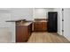 Finished basement kitchenette featuring wood cabinets, countertops, and backsplash at 109 Aspenridge Dr, Holly Springs, NC 27540