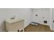 Bright laundry room with large utility sink and tile floors, perfect for tackling chores with ease at 109 Aspenridge Dr, Holly Springs, NC 27540