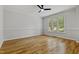 Bright and airy living room with hardwood floors, a ceiling fan, and large windows at 109 Aspenridge Dr, Holly Springs, NC 27540