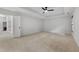 The main bedroom offers neutral colored carpet, a tray ceiling, ceiling fan, and a walk in closet at 109 Aspenridge Dr, Holly Springs, NC 27540