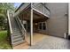 Outdoor patio with brick flooring, stairs, and access to the backyard at 109 Aspenridge Dr, Holly Springs, NC 27540