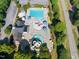 Aerial view of community pool area with multiple pools, slides, umbrellas and lounge chairs at 109 Aspenridge Dr, Holly Springs, NC 27540