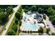 Aerial image of the community pool, slides, splash pad, plenty of chairs, and ample parking nearby at 109 Aspenridge Dr, Holly Springs, NC 27540