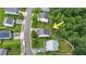 An aerial shot of homes in a suburban neighborhood, with lush trees surrounding properties at 110 Knightwood Dr, Durham, NC 27703