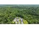 Beautiful aerial view showcases the home surrounded by mature trees and greenery at 110 Knightwood Dr, Durham, NC 27703