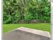 View of the patio and a well-maintained backyard, surrounded by mature trees at 110 Knightwood Dr, Durham, NC 27703