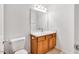 Bathroom featuring a single sink vanity with wooden cabinets and a large mirror at 110 Knightwood Dr, Durham, NC 27703