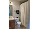 Cozy bathroom features a vanity, toilet, and shower with curtain, creating a functional space at 110 Knightwood Dr, Durham, NC 27703