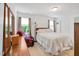 Bright bedroom with a bed, side table, and comfortable armchair next to a window at 110 Knightwood Dr, Durham, NC 27703