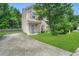 Charming two-story home with a well-maintained lawn and long private driveway at 110 Knightwood Dr, Durham, NC 27703