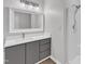 Well-lit bathroom featuring modern vanity, a sink, and shower at 1202 Kendall Dr, Durham, NC 27703