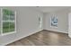 Bright bedroom with three windows, wood-look flooring, neutral walls and ample natural light at 1202 Kendall Dr, Durham, NC 27703