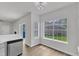 Bright dining area featuring stainless steel dishwasher, wood look flooring and abundant natural light at 1202 Kendall Dr, Durham, NC 27703
