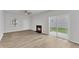 Living room featuring wood floors, a fireplace, and access to the outdoors at 1202 Kendall Dr, Durham, NC 27703