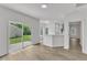 Bright and open living room with wood-look floors and sliding glass doors leading to the backyard at 1202 Kendall Dr, Durham, NC 27703