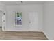 Bright living room featuring wood floors, a window, and fresh paint at 1202 Kendall Dr, Durham, NC 27703