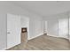 Bright living room with wood-look flooring, white walls, and a cozy fireplace visible through the doorway at 1202 Kendall Dr, Durham, NC 27703