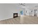 Living room featuring wood floors, fireplace, and open floorplan to the kitchen at 1202 Kendall Dr, Durham, NC 27703