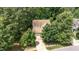 Aerial view of a home with mature trees, a driveway, and a well-maintained lawn at 1304 Barnford Mill Rd, Wake Forest, NC 27587