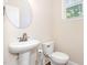 Clean bathroom with a pedestal sink and toilet, complemented by natural light from the window at 1304 Barnford Mill Rd, Wake Forest, NC 27587