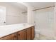 Bright bathroom featuring a vanity with modern sink, framed mirror, and shower with tub combo at 1304 Barnford Mill Rd, Wake Forest, NC 27587